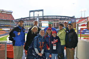 Our tour group huddled up at Shea Stadium w Citi Field in the background