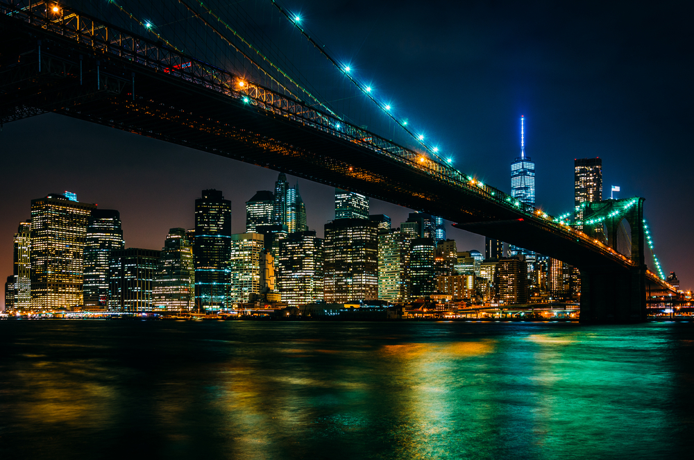 The Brooklyn Bridge and Manhattan Skyline at night seen from Brooklyn Bridge Park, New York.